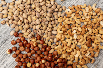 pistachio nuts cashew hazelnuts on wooden background