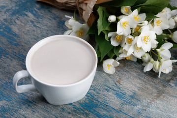 Romantic breakfast. Bouquet of jasmine. A cup of hot cocoa and Belgian waffle.