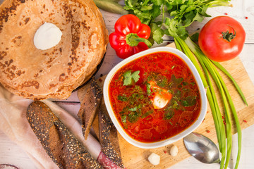 soup, borsch with greens and sour cream, pancakes with sour cream, tomato, bell pepper, onion, parsley, bread