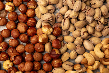 pistachio nuts cashew hazelnuts on wooden background
