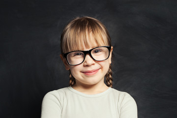 Portrait of funny cute child on school classroom background