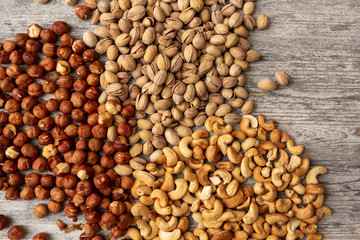 pistachio nuts cashew hazelnuts on wooden background