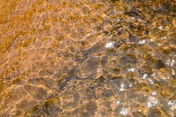 Top view pattern of water on the stone that is affected from light distortion.