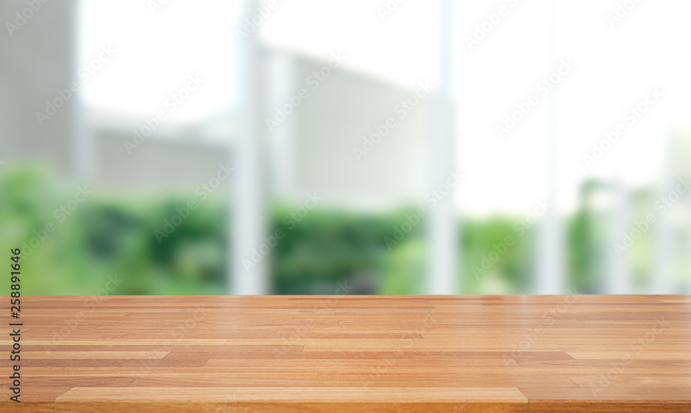 Poster empty of wood table top on blur of abstract green from garden with sunlight and window background , 