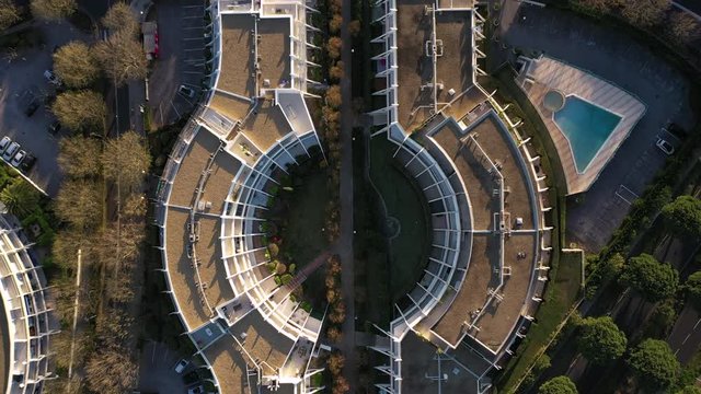 Aerial vertical view over a resort with swimming pool in La Grande Motte France. Sunset time. Seventies architecture