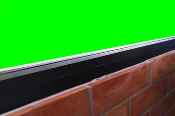 Window glass .View inside the room decorated with red brick and green screen Isolated on background with clipping path.that the space for its shows.