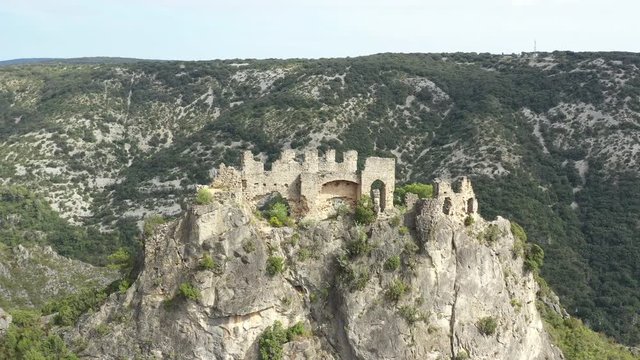 Aerial shot flying over ruins Castle of Verdun or the Giants in Saint Guilhem le Desert France. 