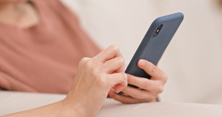 Woman use mobile phone online at home