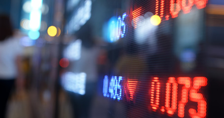 Stock market display screen in city at night