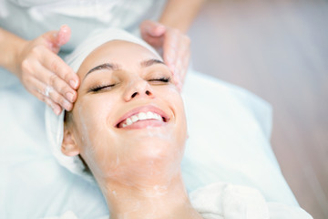 Obraz na płótnie Canvas Close up of cosmetologist hands doing massage with mask. Facial treatment. Spa procedure.