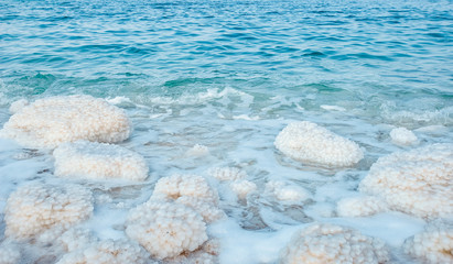 .incredibly beautiful seaside of the dead sea with blue water and white crystals of salt...