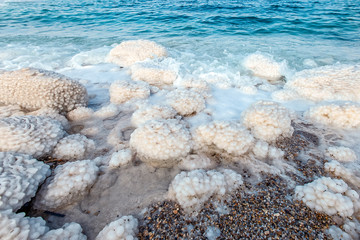 .incredibly beautiful seaside of the dead sea with blue water and white crystals of salt...