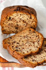 Banana cake on a wooden background with a glass of milk
