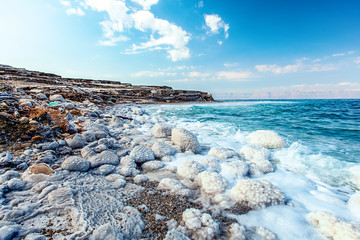 .incredibly beautiful seaside of the dead sea with blue water and white crystals of salt near.selective focus - 258897685