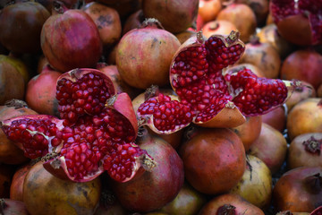 man selling red pomegranate, on a Indian street market 