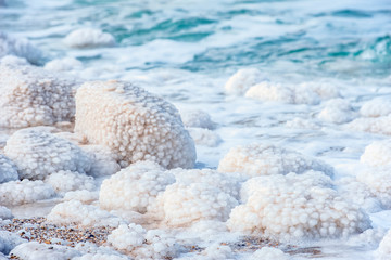 .incredibly beautiful seaside of the dead sea with blue water and white crystals of salt...