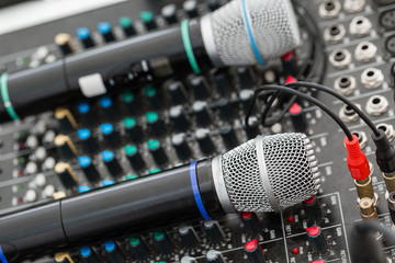 Microphone close-up. Focus on mic. Event concept. Music mixer equalizer console for mixer control...