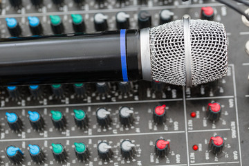 Microphone close-up. Focus on mic. Event concept. Music mixer equalizer console for mixer control...