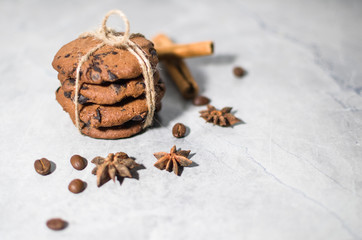 chocolate cookies with cinnamon and coffee on the table