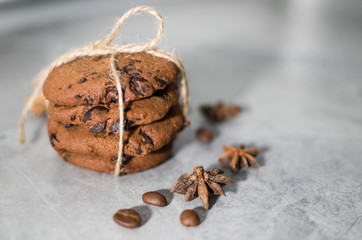 Fototapeta na wymiar chocolate cookies with cinnamon and coffee on the table