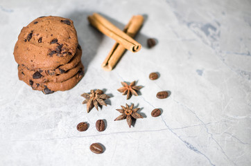 chocolate cookies with cinnamon and coffee on the table
