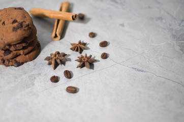 chocolate cookies with cinnamon and coffee on the table