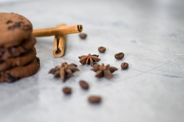 chocolate cookies with cinnamon and coffee on the table