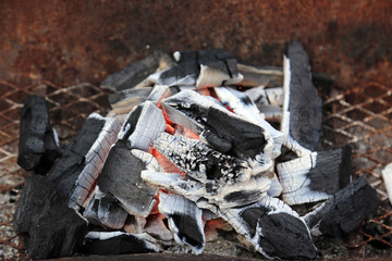 Charcoal burning in stove for cooking barbecue.