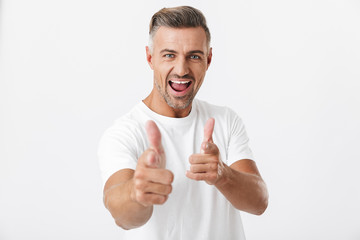 Image of joyful man 30s with bristle wearing casual t-shirt showing thumbs up on camera