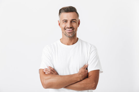 Image of optimistic man 30s with bristle wearing casual t-shirt posing and looking on camera