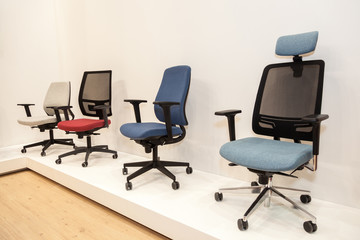 modern chairs with colorful upholstered near beige wall