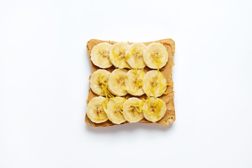 Healthy vegan breakfast concept. No bake no crunch peanut butter sandwich with strawberry, perfectly toasted bread, clean eating food. White table background. Top view, close up, copy space, flat lay.