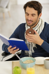 man eating doughnut for breakfast