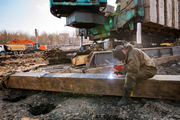 man engaged in welding metal