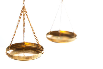 Justice law judge brass balance scales on white background. Close up with free space.