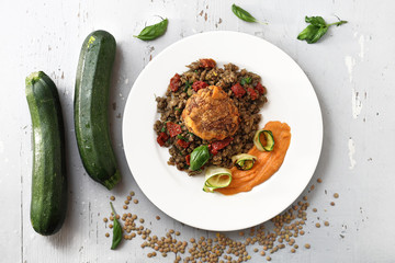 Lentils, vegetable cutlet with carrot puree and grilled zucchini. Colorful vegetable meatless dish.