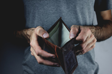 young man holding empty wallet