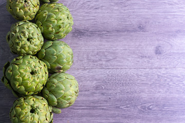 artichokes on grey background. fresh organic artichoke flower