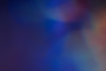 Blurry blue lights on dark background. Defocused lens flare glow. Abstract design.
