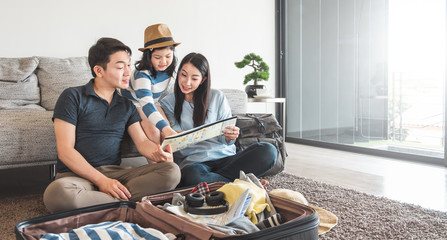 Asian family packing bag/luggage and planning to travel on summer vacation