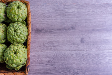 Freshly harvested artichokes in a basket, vegetables for a healthy diet.