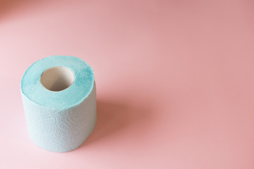 top view roll of blue toilet paper on pink background copy space