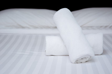 Set of towel on the bed in the room in hotel close up.