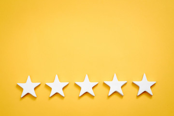 Top quality rating. Evaluation and classification. Five white stars on yellow background. Copy space.