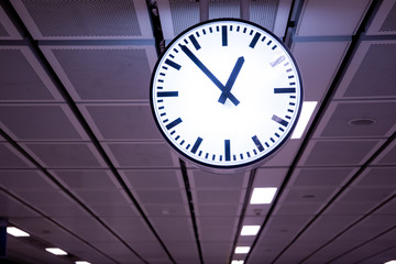 Obraz premium Big clock in the public area close up. The time is 12.53 pm.