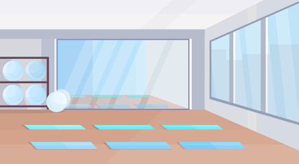 yoga studio healthy lifestyle concept empty no people gym interior design with mats fit balls mirror and windows horizontal