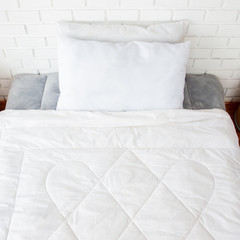 Fototapeta na wymiar Flat white bed in bedroom decorated in vintage style.