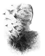 Paintography. Double Exposure portrait of an elegant woman with closed eyes combined with hand made pencil drawing of a flock of birds flying freely resembling
