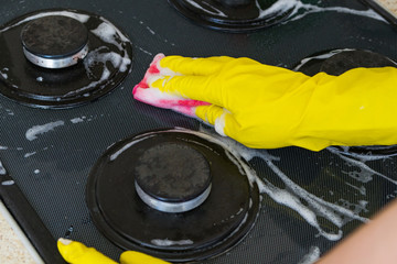 washing of gas cooker from glass ceramics. black hob