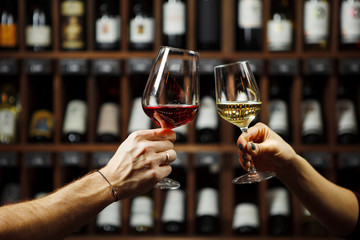Man and woman drinking red and white wine together